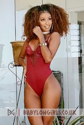 Smiling black Brazilian girl in a red, lace body