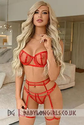 Blonde Russian with long curvy hair in a red bra and panties