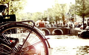 A picture of a scene in Amsterdam with bicycles, canals and Dutch escorts