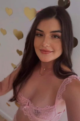 Close up selfie of a very pretty Brazilian girl with a cheeky smile