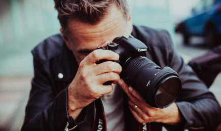 Professional escort photographer taking a photo with a Canon camera