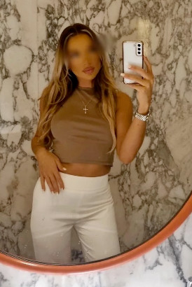 High class blond taking a sexy selfie in a mirror
