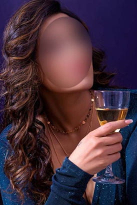Beautiful Indian woman holding a glass of champagne