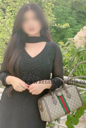 Young Indian girl in a black dress and holding a Gucci handbag