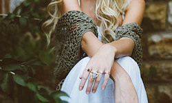 A cropped image of a blonde woman in summer clothes