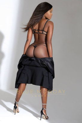 Striking photo of a petite black girl in a g-string wiht her back to the camera