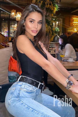 Sexy brunette casually dressed in jeans and a black top