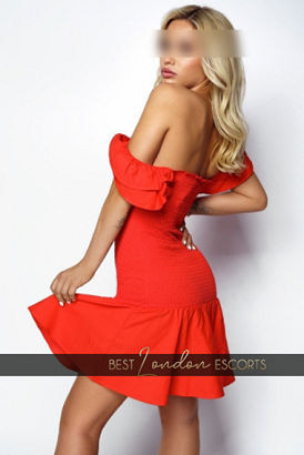 Sexy blond girl in a red low cut dress