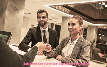 Business man and woman checking into a hotel